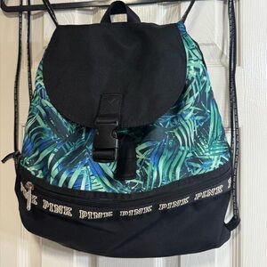 PINK backpack. Blue & green palm motif. Drawstring & buckle closure.